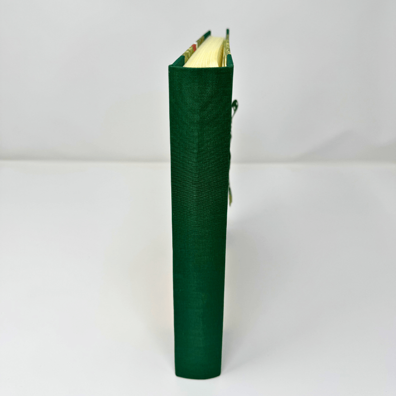 Album fotografico Cappuccetto Rosso rilegato a mano in verde, vista laterale del libro artigianale.